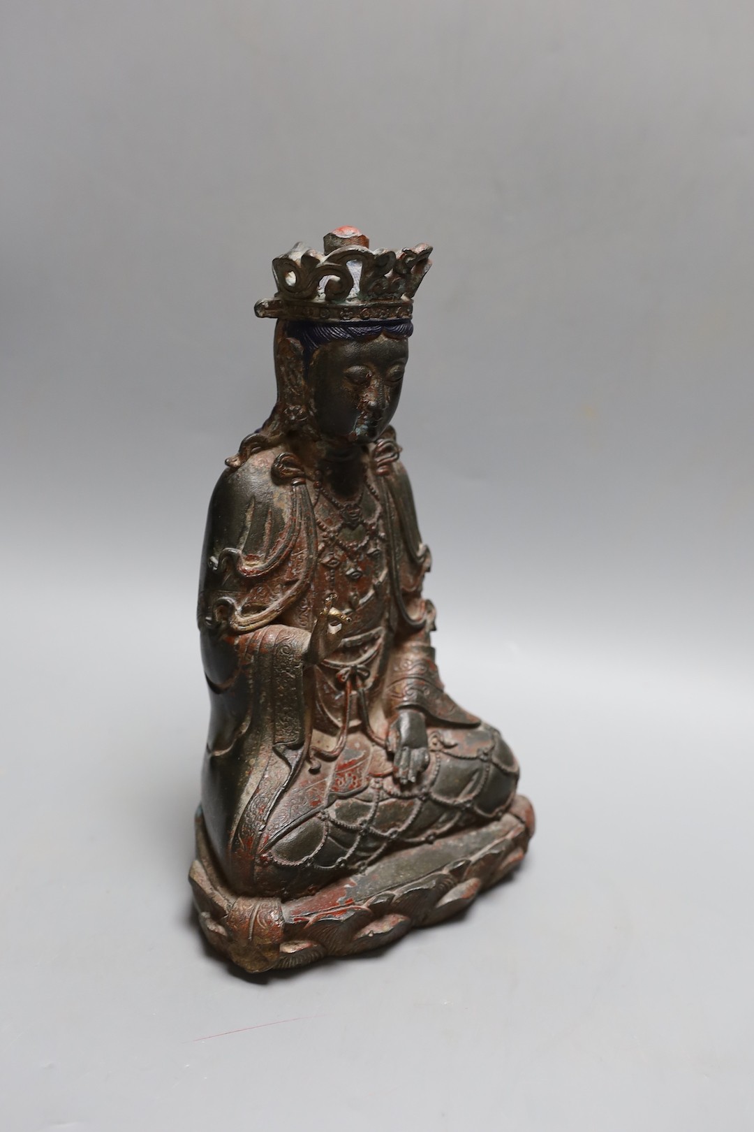 A Chinese Ming style bronze seated figure of Guanyin, 25cm